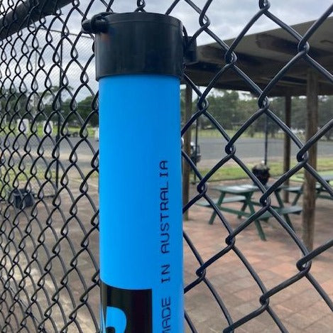 Tennis Ball Pickup Tube hanging on fence